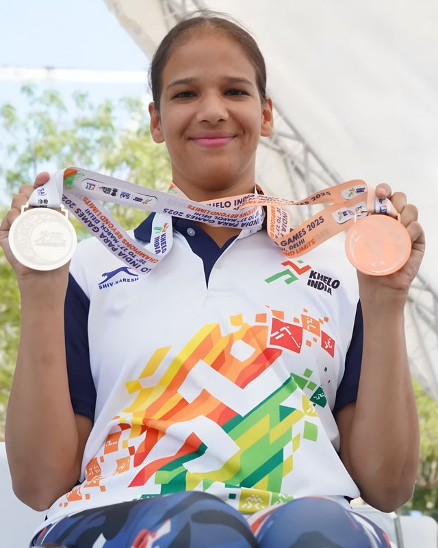 Garima Joshi holding two medals